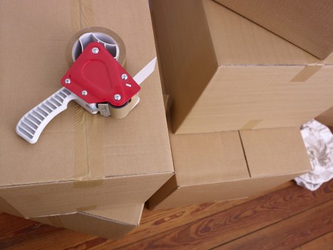 Professional removal team handling boxes in a Kensington flat