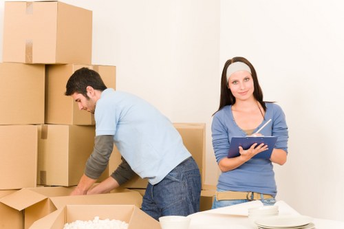 Professional movers handling a flat move in Kensington with stairs and narrow access