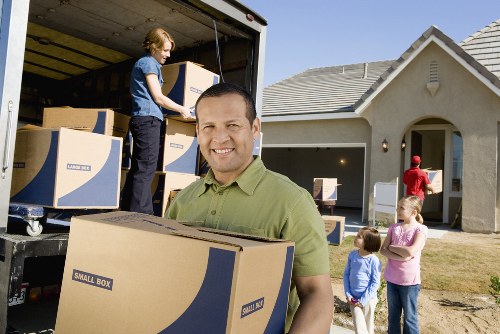 Local movers carrying furniture for a Kensington home or flat relocation